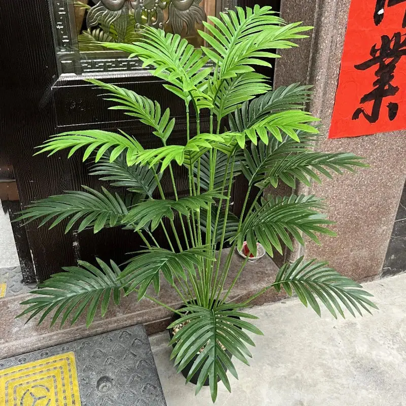 Large artificial palm tree with monstera branches for outdoor decor... Livraison Express